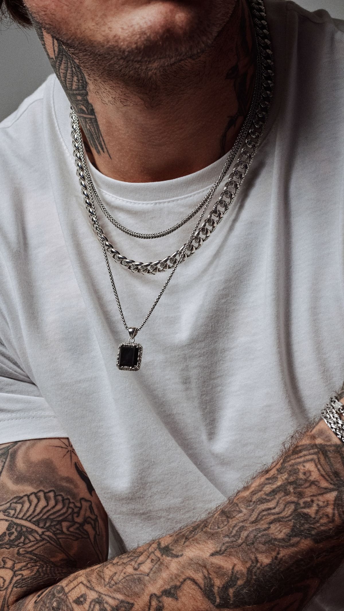 Editorial styling of a bracelet with a casual ivory shirt